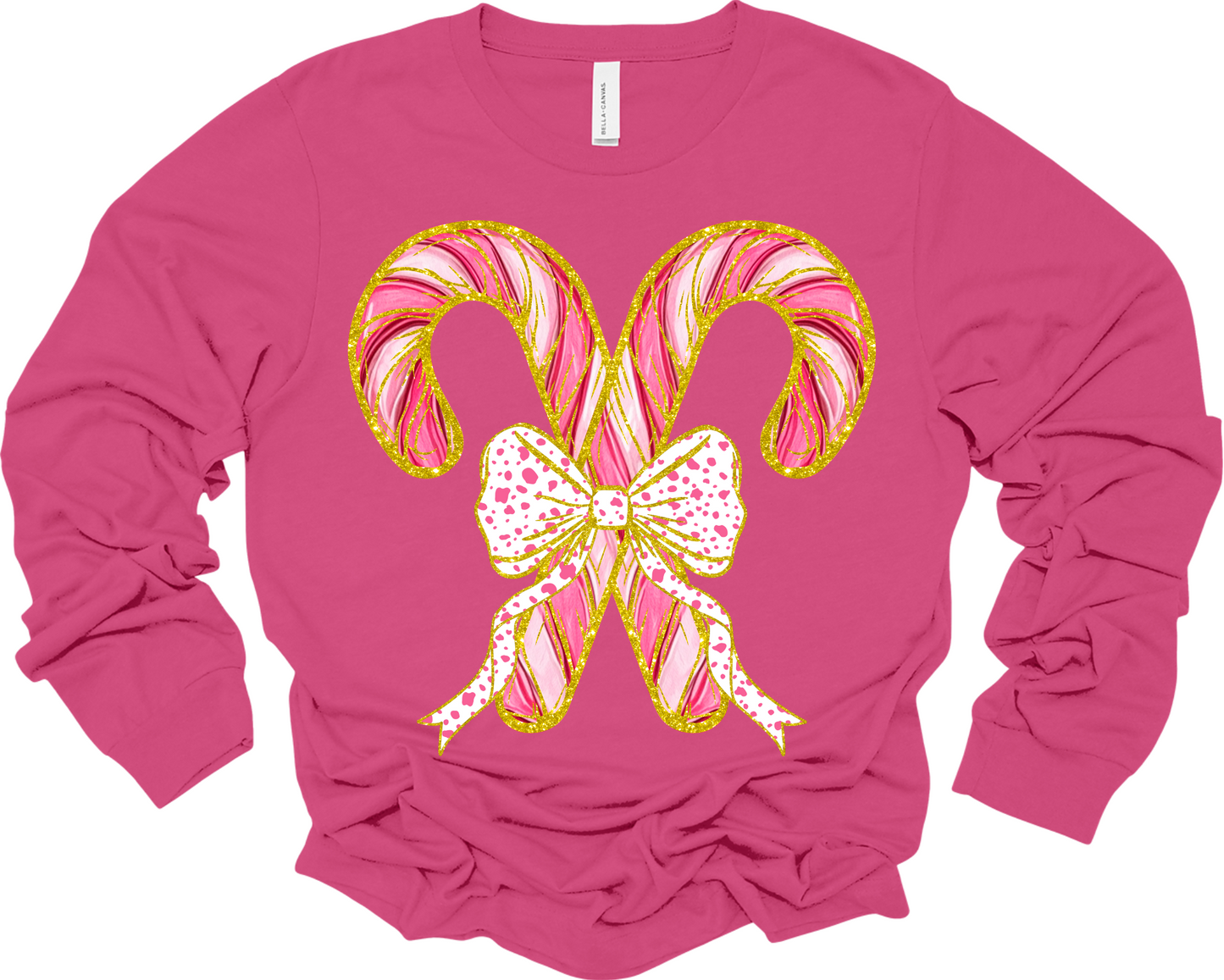 Long sleeve pink t-shirt with two criss crossed candy canes outline in faux gold glitter with a polka dot bow image.